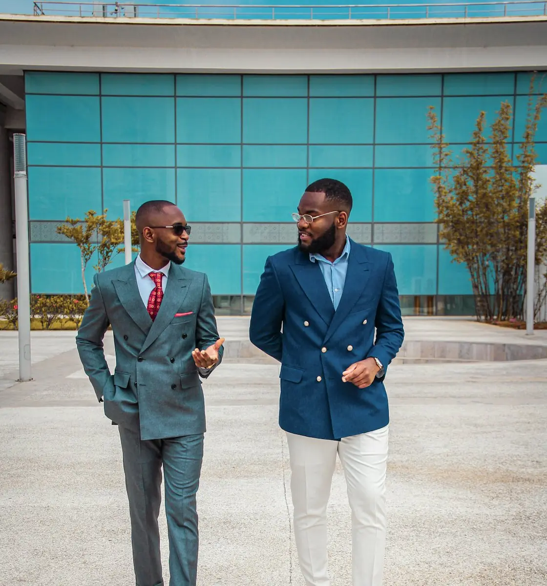 Two confident African executives outside a modern building