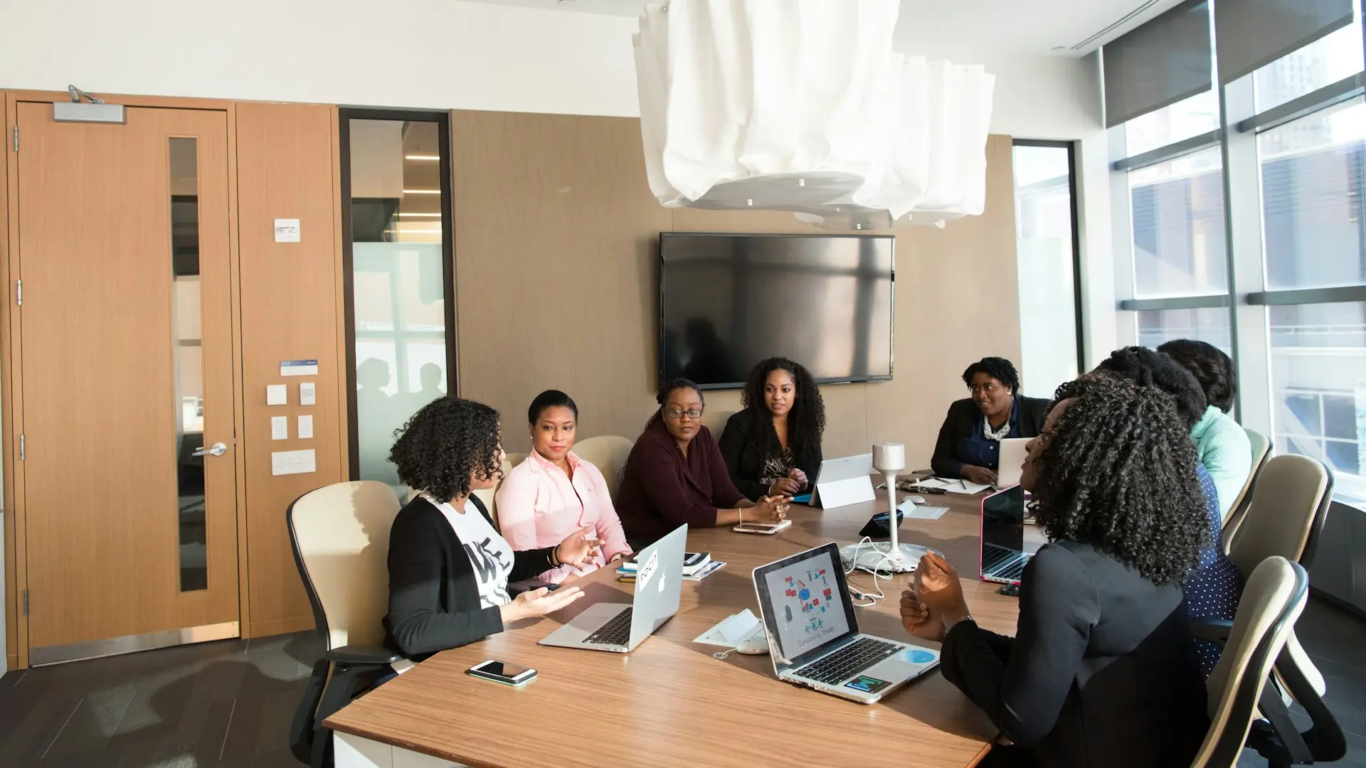 A diverse team of African professionals collaborating around a table in a modern office